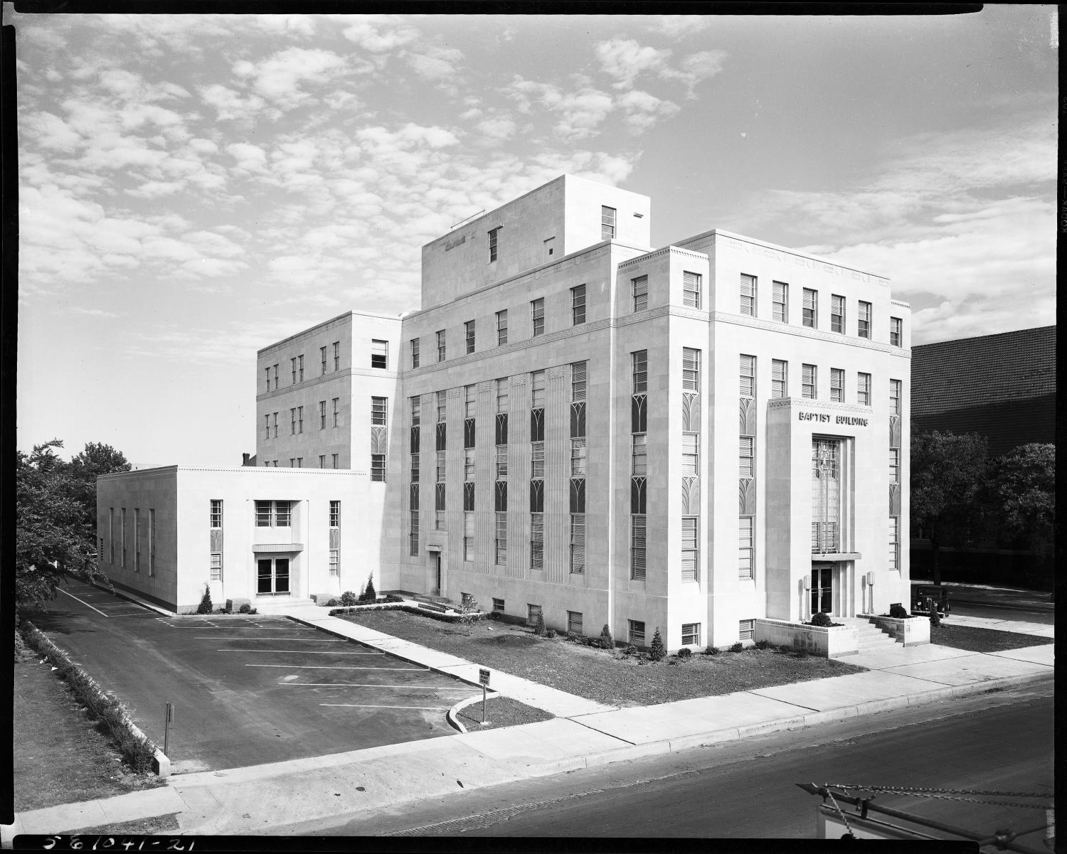 May 1950: the completed Baptist Building seen from the southeast, its limestone facade lettered BAPTIST BUILDING over the entrance, with a new surface parking lot beside it