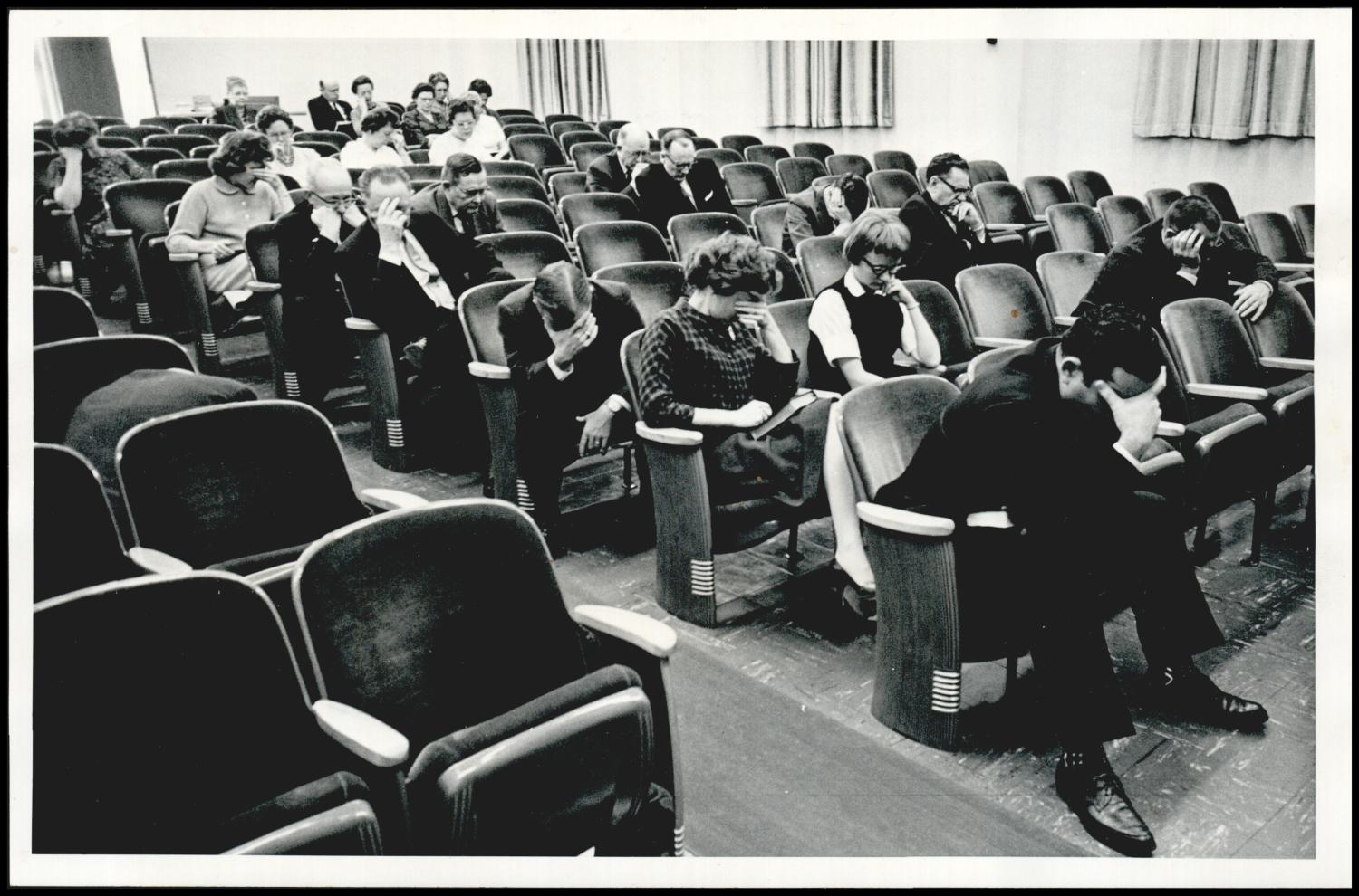A prayer meeting filling the auditorium seats in December 1962